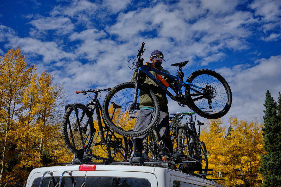 Loading mountain bikes on Shuttle Taos' van at the south boundary trail.